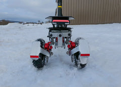 Robot with wheels and red components on a snowy ground