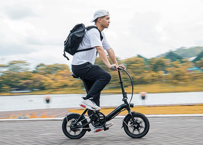 Fiido D3 Pro electric bike black side view riding outdoors by a lake