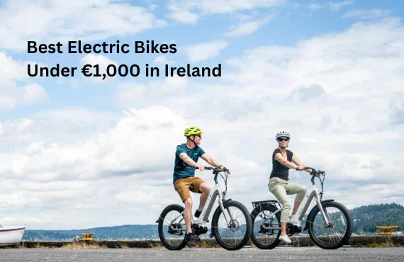 Two adults riding grey electric bikes on a paved path with a scenic outdoor background