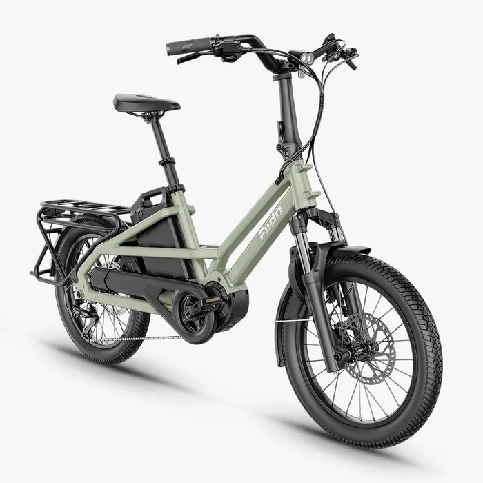 A 27.5-inch FIIDO T31 folding electric bicycle in a muted sage green frame with black components, including the seat, handlebars, tires, and battery pack, shown on a light gray background.