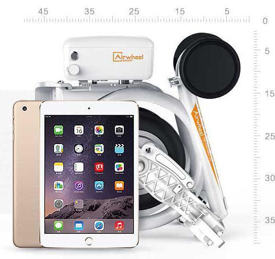 Airwheel E3 folding electric bike in white, side view, folded compact next to a tablet for scale